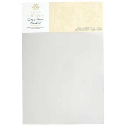 Elegant patterned Luxury Mirror Foil Cardstock with a floral design header featuring subtle embossing. Labeled "Anna Griffin," it includes contact information and states "Made in China.