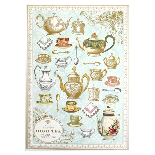 The puzzle box cover features ornate teapots, cups, and silverware illustrations on a light blue background. Text reads "High Tea Jigsaw Puzzle - 750 Piece." Ideal for puzzle lovers and tea enthusiasts.