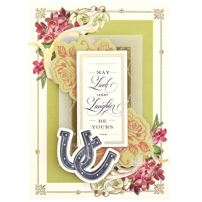 Greeting card with a floral design, featuring two horseshoes and a scrapbook page charm. Text reads, "May Luck and Laughter Be Yours," reflecting the heartfelt message of Lucky Stamps Dies.