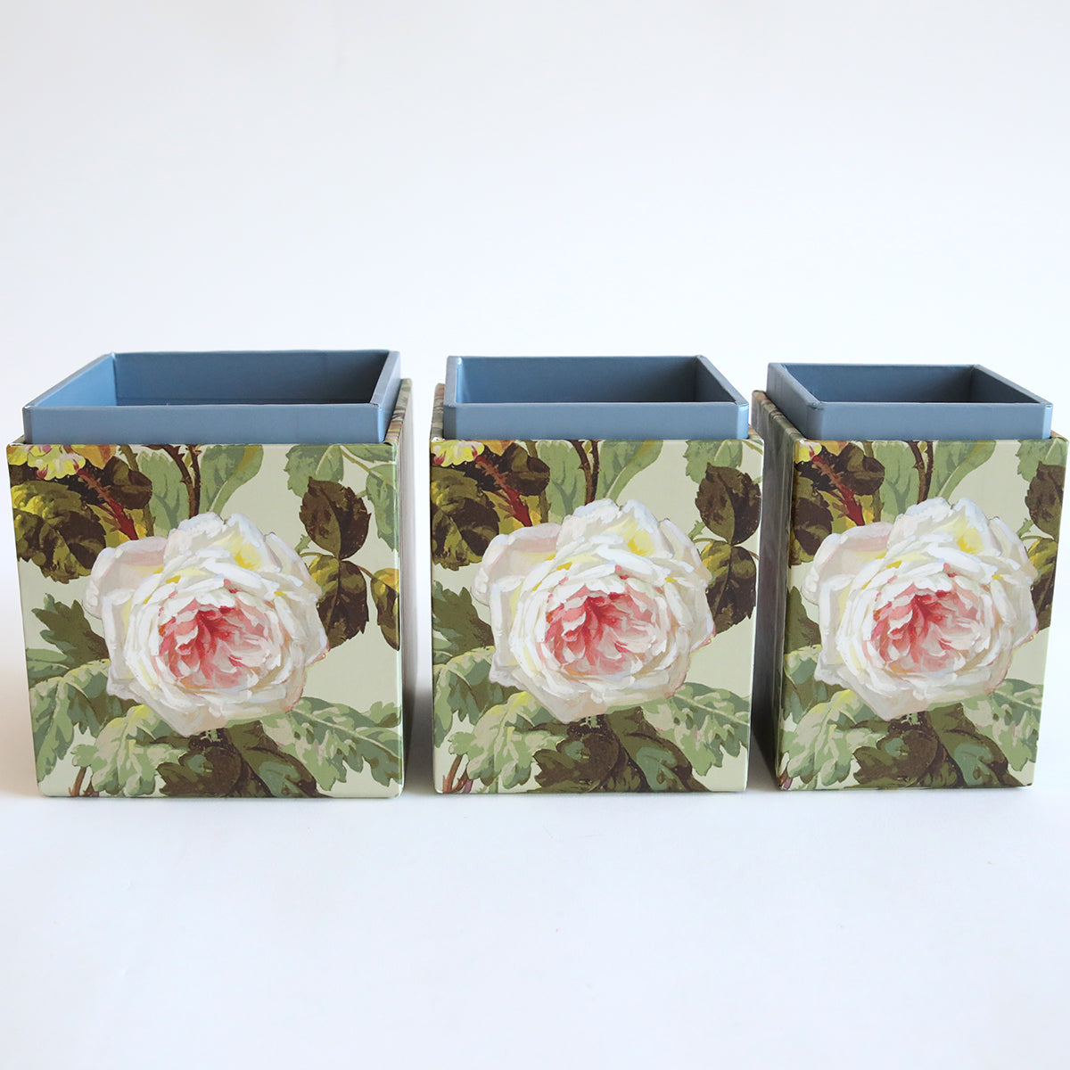 The Francesca Craft Storage offers three square planters with floral patterns showcasing pink roses and green leaves on a light background, adding charm to your space.