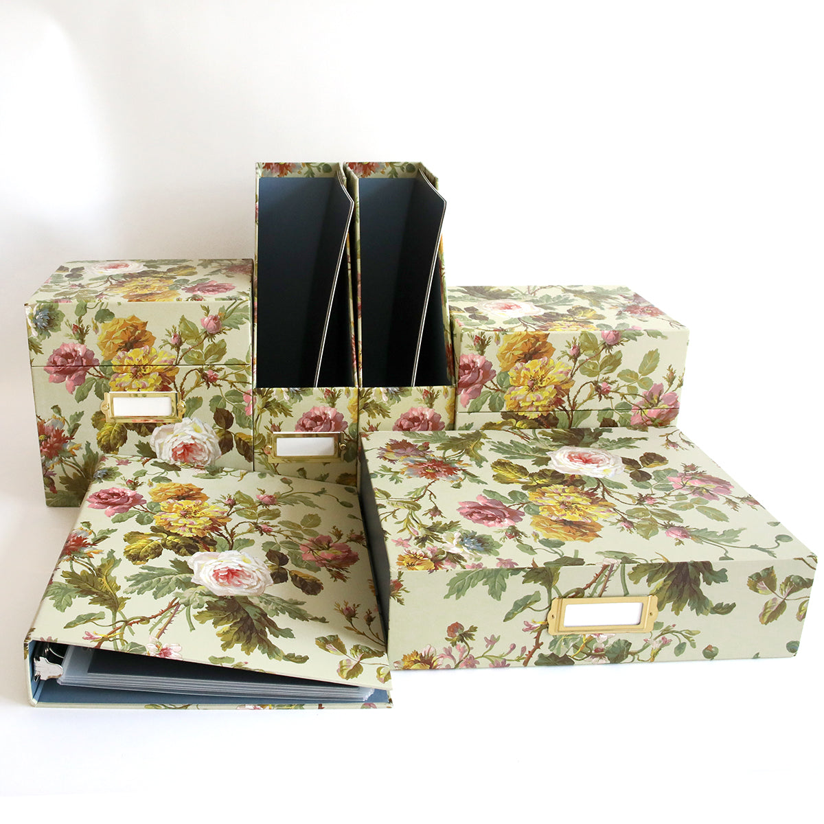 Francesca Craft Storage offers floral-patterned boxes and magazine holders, ideal for organizing craft materials or embellishments. Available in various sizes with labels, they are beautifully displayed on a white background.