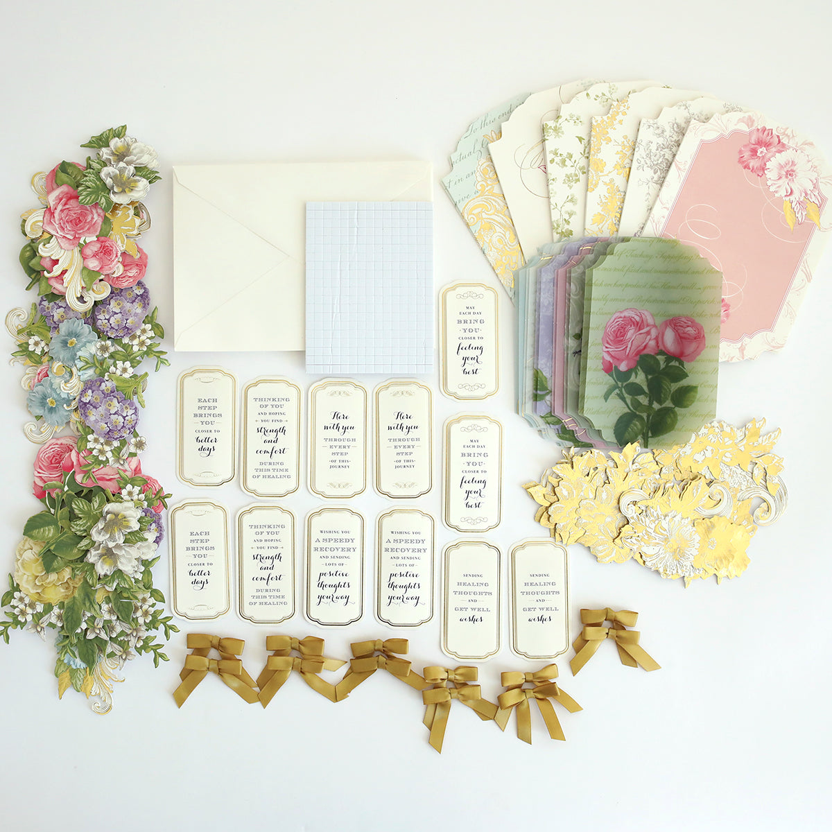 The Simply Get Well Card Making Kit offers a vintage-style collection with floral-patterned paper, envelopes, 3D embellishments, paper flowers, and yellow ribbons, all beautifully arranged on a light background.