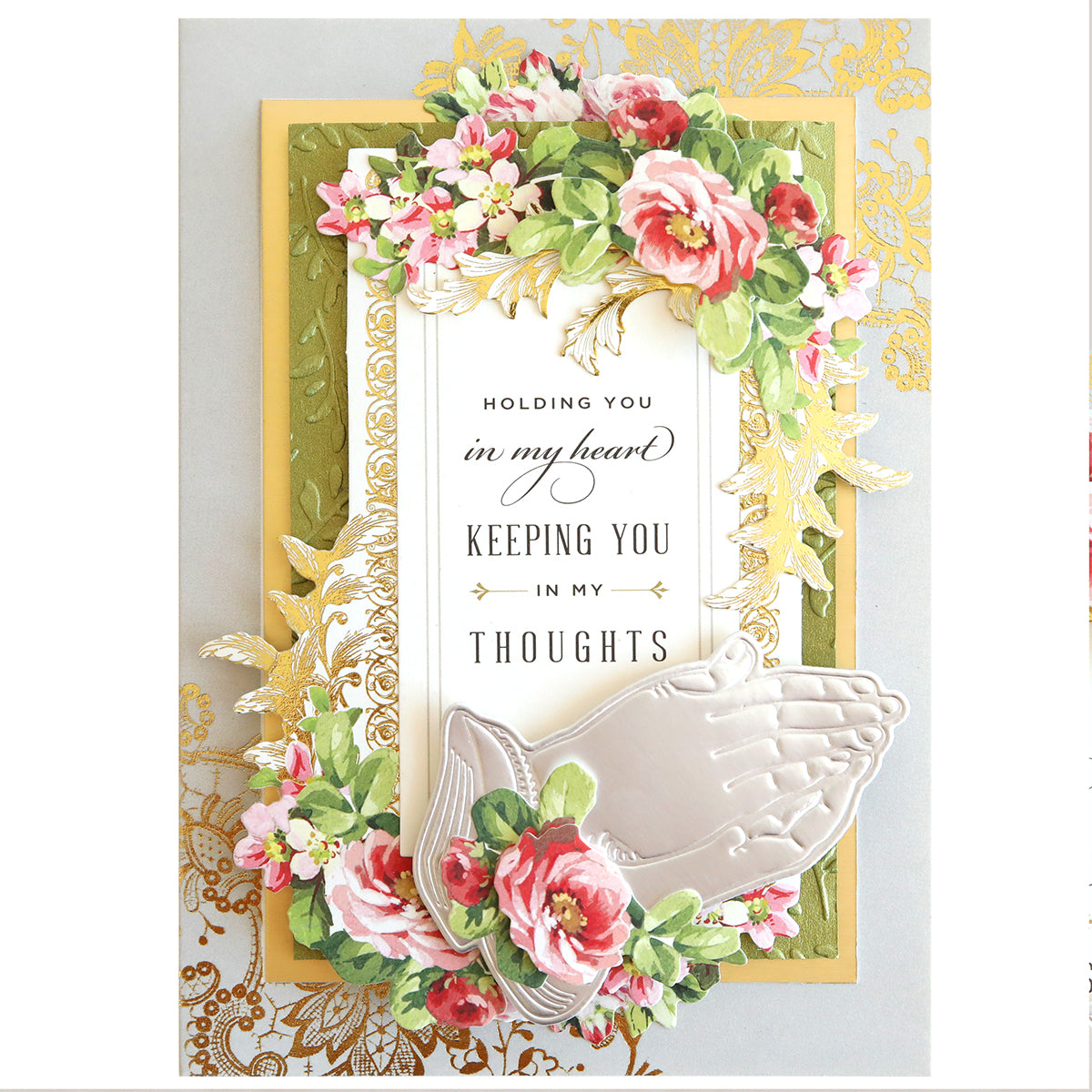 The Praying Hands Dies card features vibrant floral designs and stained glass elements with the message "Holding you in my heart, keeping you in my thoughts." It includes embossed praying hands at the bottom, capturing the essence of religious holidays.