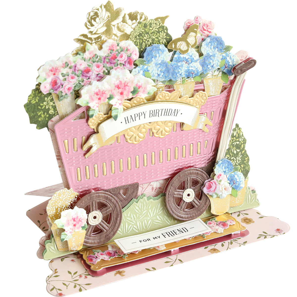 3D birthday card made with the 3D Wagon Easel Die Set, showcasing a pink garden wagon filled with vibrant flowers and displaying a "Happy Birthday" banner. The base reads "For My Friend.