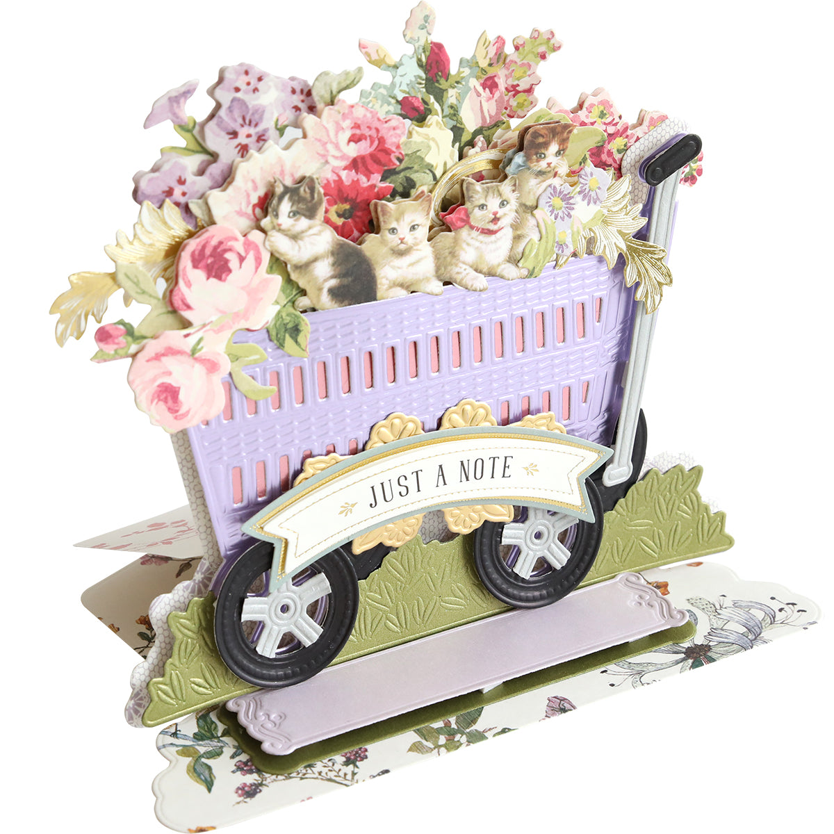 A charming pop-up card created using the 3D Wagon Easel Die Set features a garden wagon filled with kittens in a floral basket on scooter wheels, complete with a "Just a Note" banner.