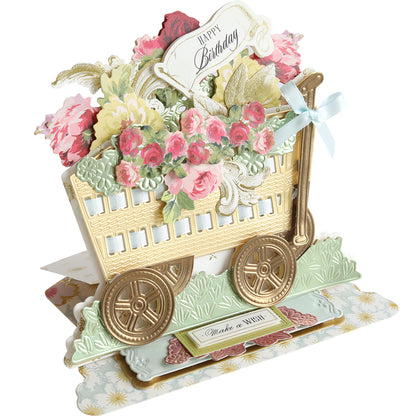 The 3D Wagon Easel Die Set birthday card features a vintage garden wagon design with vibrant flowers and a cheerful "Happy Birthday" sign.