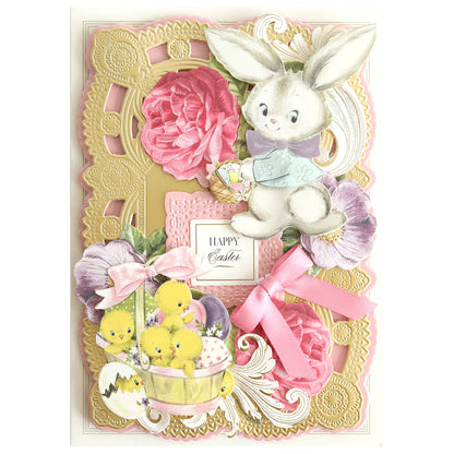 The "Bunnies and Chicks Embellishment Stickers" Easter card displays a bunny, chicks in a basket, and flowers with elegant pink and gold designs. It features springtime crafts like embellishment stickers that radiate cheer with a central "Happy Easter" message.