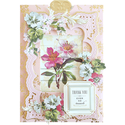 The Clever Sliding Card Die Set lets you create a floral-themed thank you card, showcasing pink and white flowers in a delicate frame design. The heartfelt message "Thank You Ever So Much" graces the bottom right corner, crafted with handmade precision for added warmth.