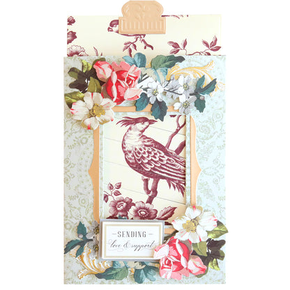 A decorative card, crafted with the Clever Sliding Card Die Set, features a bird illustration framed by floral designs and the text "Sending Love & Support.