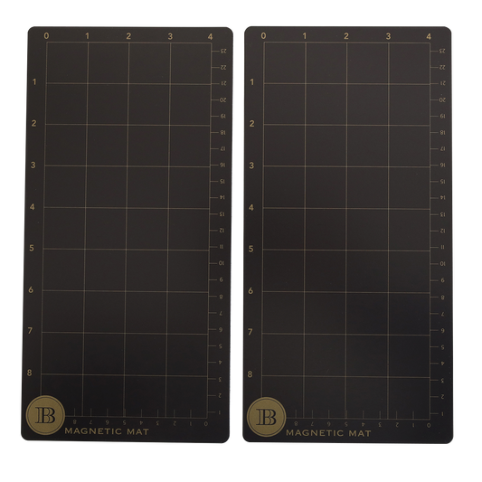 The Empress Elite Mini 5" x 10" Set of 2 Magnet Mats features two black rectangular mats with grid lines, numbered axes, “Magnetic Mat” labels, and gold “B” logos—ideal magnetic surfaces for accurate die cutting.