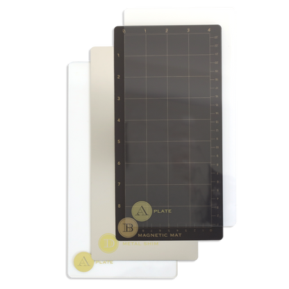 Three rectangular plates—a 5" x 10", a 13", and a magnetic grid mat—are fanned out on white, perfect accessories for your Empress Elite Mini Machine with 5" x 10" and 13" plates.