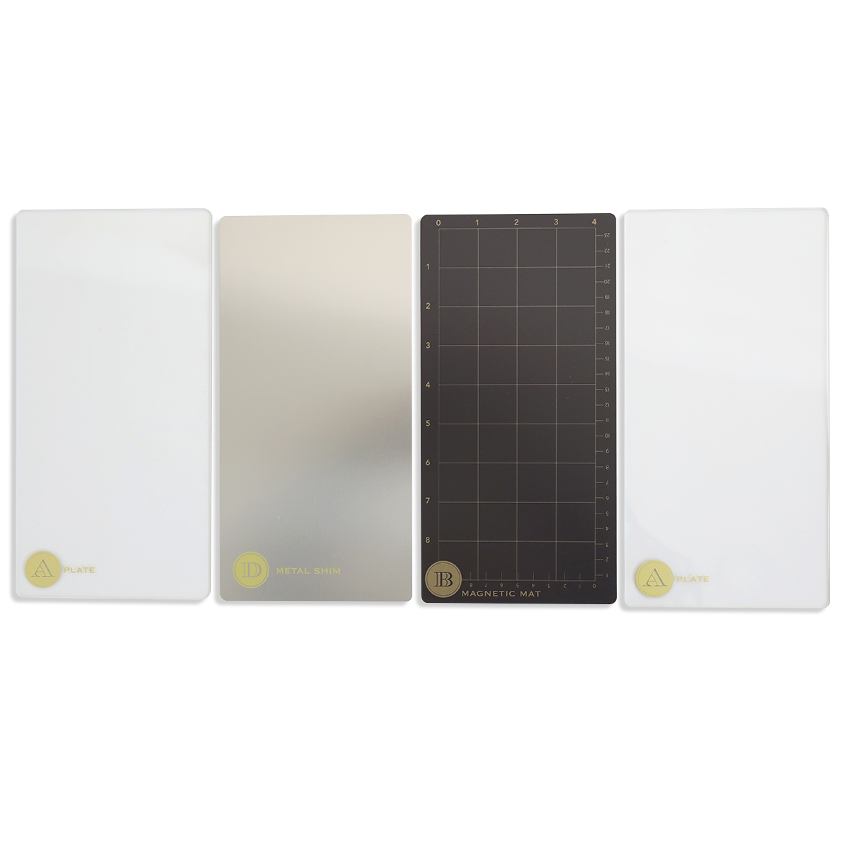 Four rectangular die cutting plates are arranged side by side: two white, one metallic, and one black grid-labeled "IB Magnetic Mat" from the Empress Elite Mini 5" x 10" Full Plate Set by Anna Griffin.