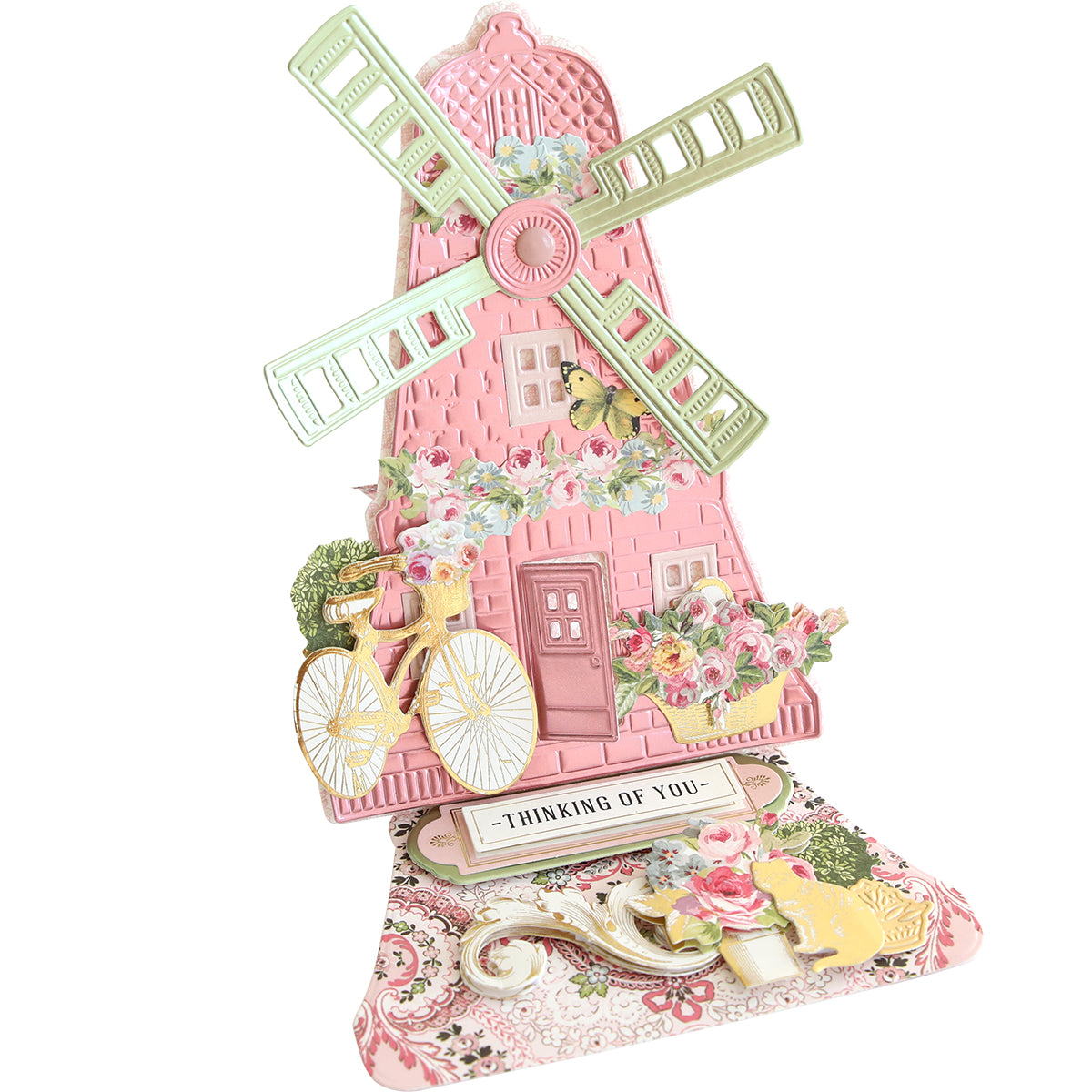 3D Windmill Easel Dies features a pop-up card design with a pink windmill, green blades, floral accents, a bicycle motif, and a "Thinking of You" message on its decorative base.