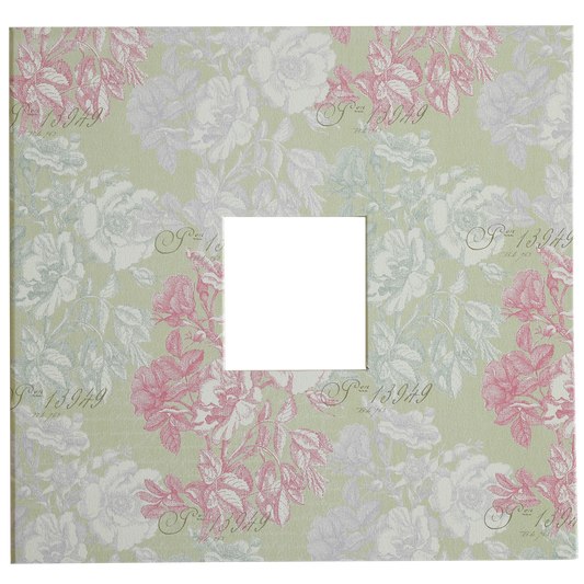 A square cut-out is centered on the pale green patterned cover of the Antique Botanical Scrapbook Album, featuring pink and white floral motifs and faint script text in the background.