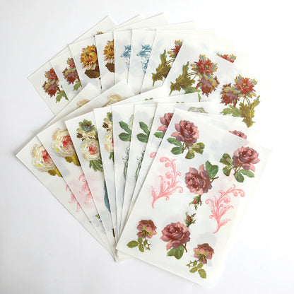 Several sheets of decorative floral rub on transfers from the Ultimate Francesca Papercrafting Collection with Rub Ons are spread out in a fan shape on a white background, showcasing roses and other flowers in a variety of colors and designs. These versatile stickers make a lovely addition to any scrapbook supplies or the Ultimate Francesca Papercrafting Collection with Rub Ons.