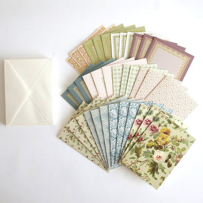 A set of Francesca Cards and Envelopes, showcasing handmade card designs with beautiful patterns and florals, is displayed fanned out beside a single plain white envelope on a white background.