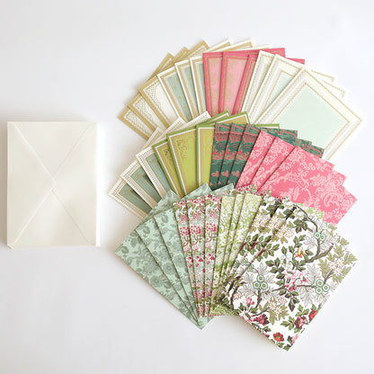 Lian Embellishments and Cards: a selection of patterned and plain handmade cards in green, pink, and cream, arranged in a semicircle with a white envelope—ideal for adding embellishments or 3D stickers.