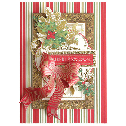 The Christmas Present Card Making Kit includes a handmade card with red and gold accents, a striped red bow, holly leaves, and "Merry Christmas" on a striped background—ideal for enhancing your holiday card collection.