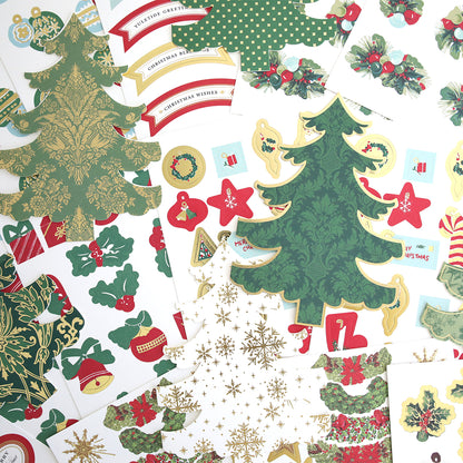 Tree Shaped Cards and Embellishments feature assorted Christmas-themed paper cutouts, like decorated trees, holly, ornaments, and festive banners—perfect for holiday greeting cards—arranged on a white surface.