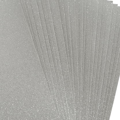 A stack of silver glitter paper on a white background.