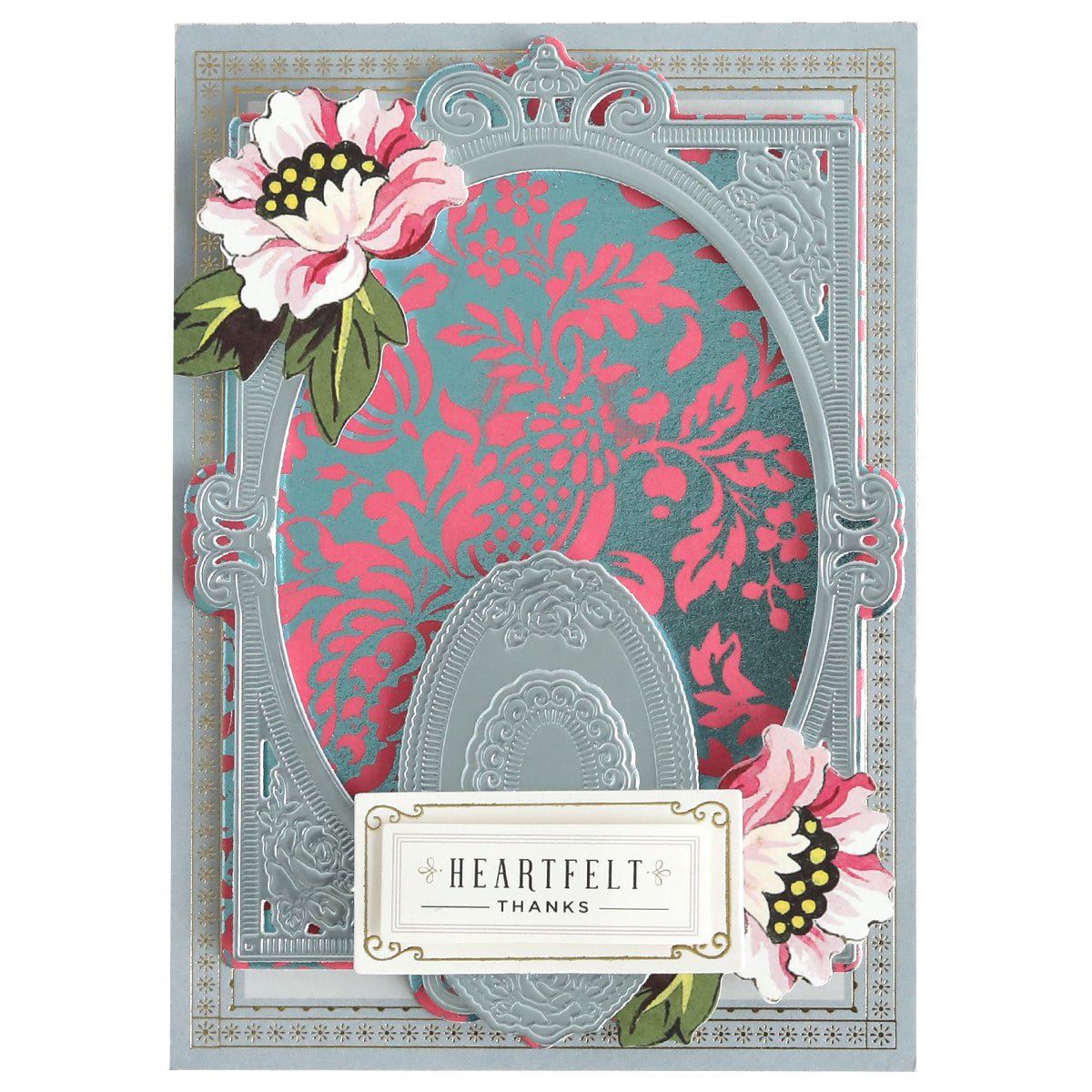 A decorative greeting card with an ornate silver frame, floral accents, and a “Heartfelt Thanks” label on Color Drenched Cardstock French Blue—perfect for card making with hot foil plates.