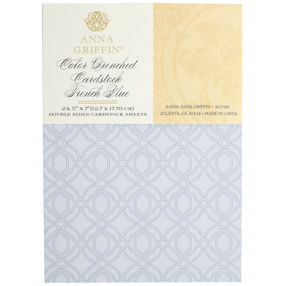 A pack of Color Drenched Cardstock French Blue double-sided sheets with an intricate circular lattice pattern in light blue. Ideal for card making, the label displays product details and Anna Griffin branding.