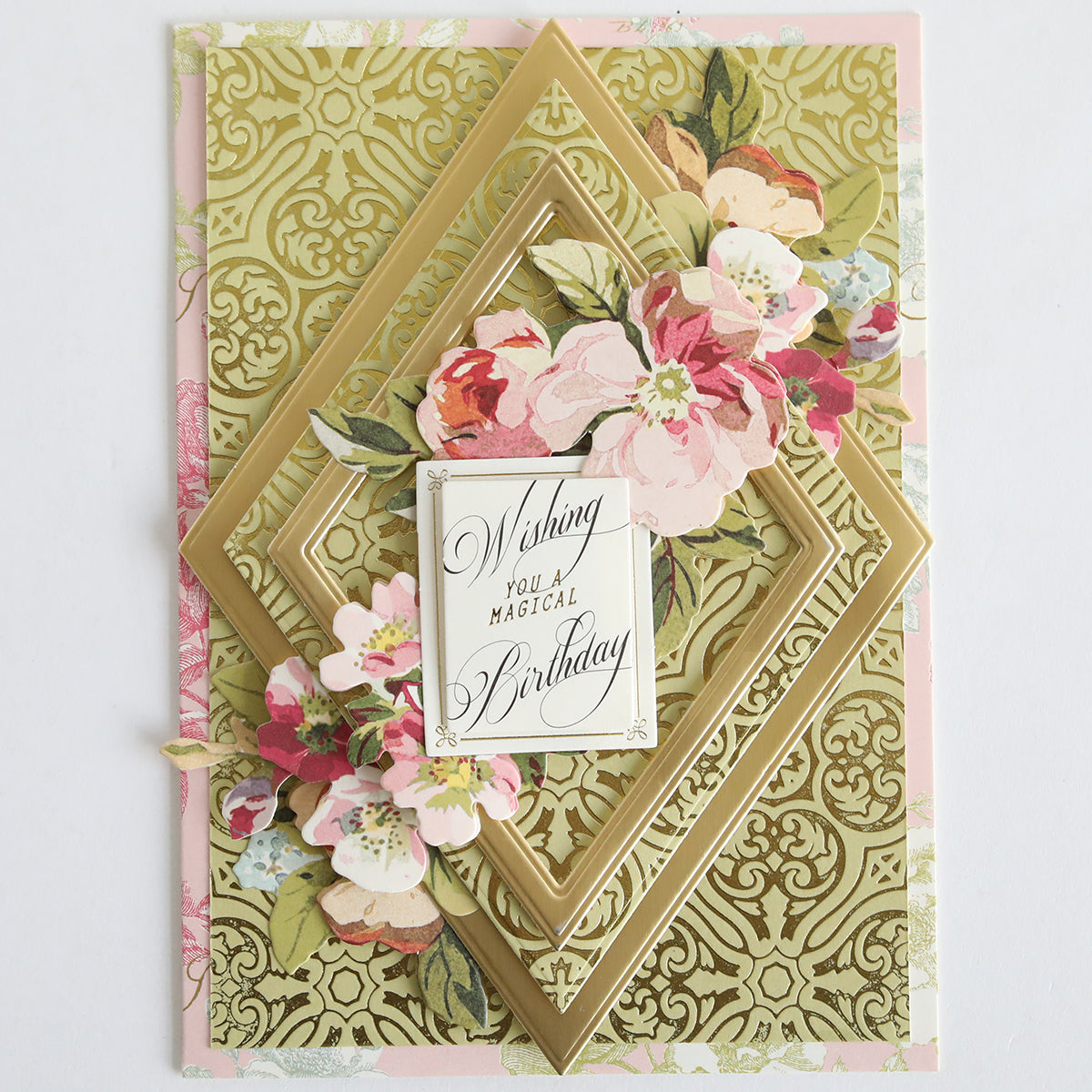 A decorative birthday card made with Color Drenched Cardstock Sage Green, gold geometric patterns, and pink floral accents features “Wishing you a magical birthday” in elegant script—ideal for card making enthusiasts.