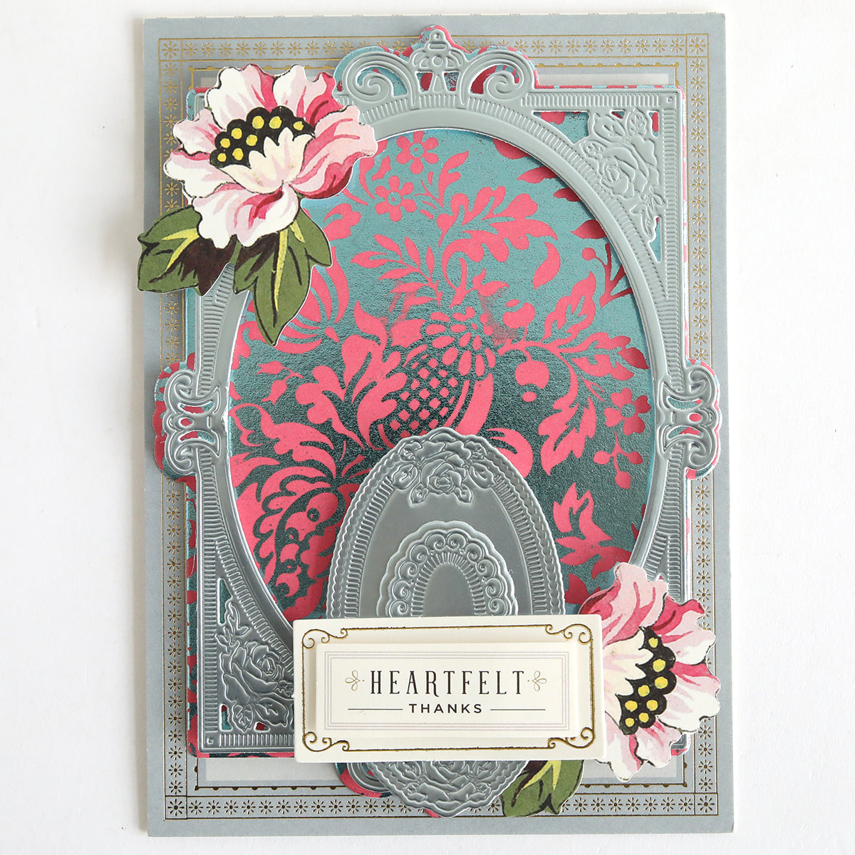 Decorative card featuring an embossed silver and pink floral design, ornate oval frame, two peonies crafted from Color Drenched Cardstock Peony Pink, and a "HEARTFELT THANKS" label—ideal for card making enthusiasts.