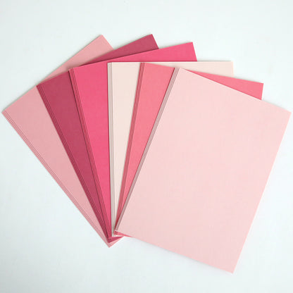 Six sheets of Color Drenched Cardstock Peony Pink in various pink shades are fanned out on a white surface—ideal for card making or use with hot foil plates.