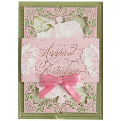 A decorative birthday card made from Color Drenched Cardstock Fresh Lilac features pink and green floral designs, gold embossed "Have the Happiest of Birthdays" text, and a pink ribbon bow at the center.