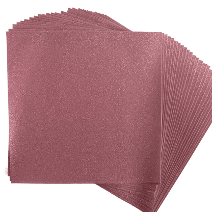 A stack of pink sanding sheets on a white background.