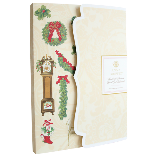 A decorative folder is partially open, revealing Garland Staircase Die Cut Stickers and other Christmas-themed scrapbook embellishments such as a wreath, grandfather clock, stocking, holly, and a bow.