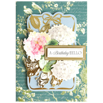 Introducing the Birthday Present Card Making Kit—a beautifully designed birthday card kit that includes premium supplies for crafting unique cards. Featuring elegant white and pink flowers, shimmering gold leaves, and the cheerful greeting "A Birthday HELLO" set against a blue and green floral background, this kit is perfect as inspiration or as a thoughtful gift for anyone who loves making handmade birthday cards.