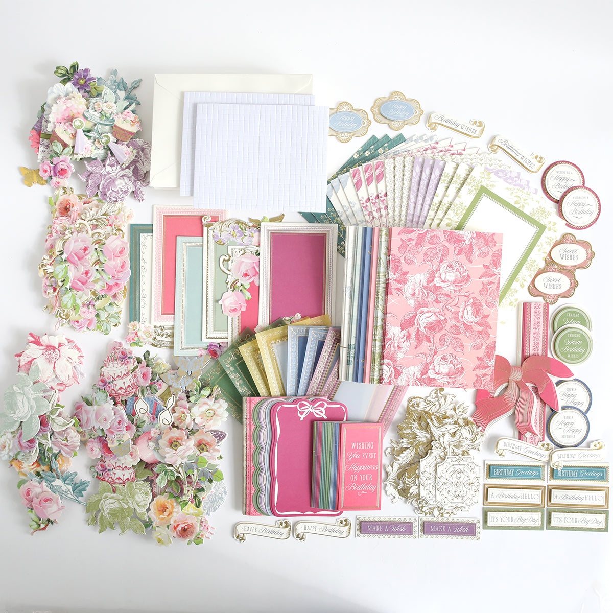The Birthday Present Card Making Kit features assorted floral-themed stationery, card making supplies, envelopes, paper cutouts, and decorative labels—perfect for handmade birthday cards—all arranged neatly on a white background.