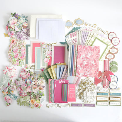 The Birthday Present Card Making Kit features assorted floral-themed stationery, card making supplies, envelopes, paper cutouts, and decorative labels—perfect for handmade birthday cards—all arranged neatly on a white background.