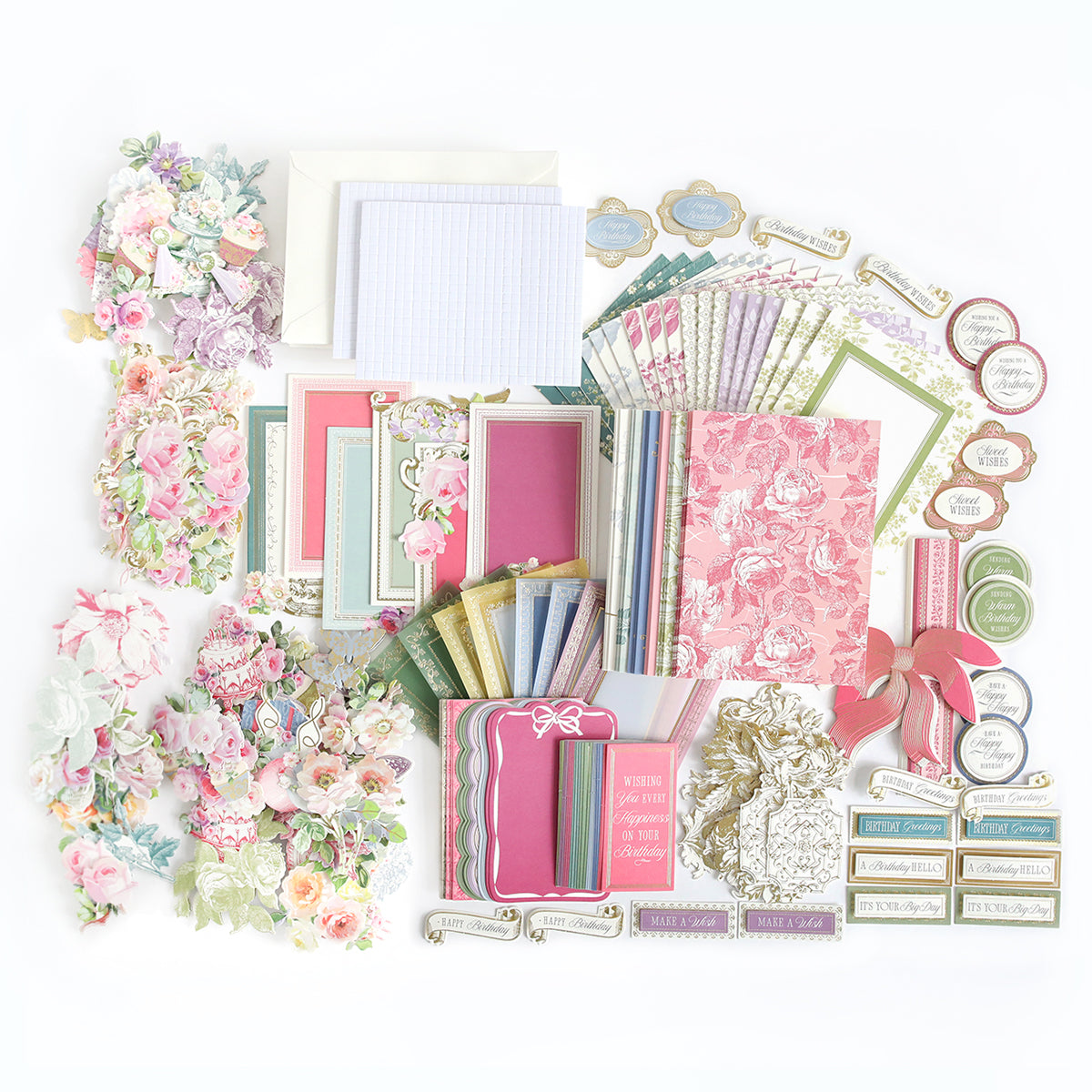 The Birthday Present Card Making Kit features an array of floral-themed stationery, envelopes, patterned papers, notecards, handmade birthday cards, die-cut embellishments, ribbons, and labels—beautifully arranged on a white surface—making it the perfect choice for anyone looking for premium card making supplies or assembling a unique gift.