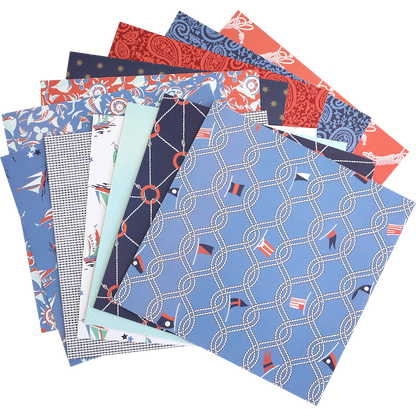 A stack of Lighthouse 12x12 Cardstock sheets with coastal nautical and geometric designs in blue, red, white, and navy tones is fanned out on a white background.