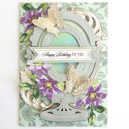 A decorative birthday card on Luxury Iridescent Foil Cardstock, adorned with gold butterflies, purple flowers, and a silver frame, featuring “Happy Birthday To You” on a central banner.