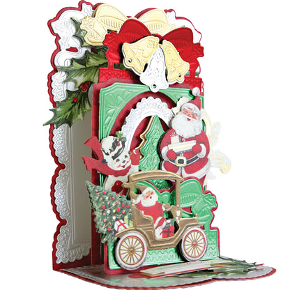 A pop-up, moveable card featuring Santa in a car with festive ornaments, holly leaves, and bells—made using the 3D Christmas Interactive Pulley Dies set with 13 dies for extra holiday fun in red, green, gold, and white.