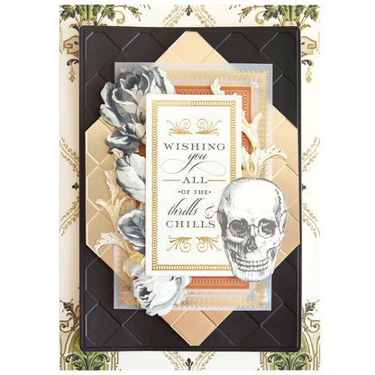 Handmade greeting card featuring gold and black geometric layers, floral accents, a skull illustration, and “Wishing you all of the thrills & chills.” Crafted using Spellbound Patterns Cut & Emboss Folders—ideal for seasonal projects.