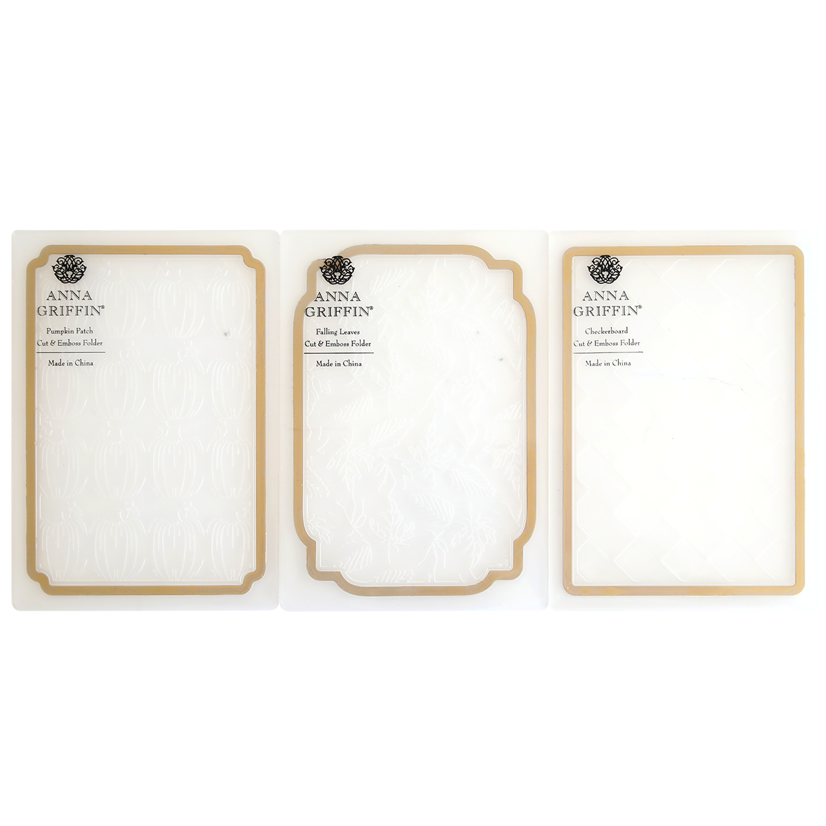 Three Spellbound Patterns Cut & Emboss Folders are displayed side by side in clear plastic packaging with gold trim—ideal for adding flair to your seasonal crafting projects.