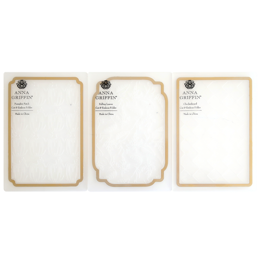 Three Spellbound Patterns Cut & Emboss Folders are displayed side by side in clear plastic packaging with gold trim—ideal for adding flair to your seasonal crafting projects.