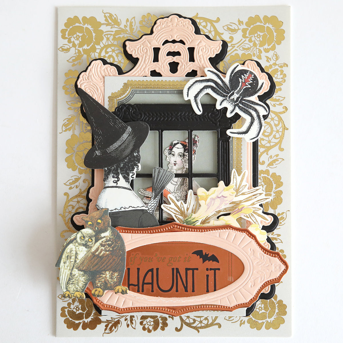 Create a decorative Halloween card using Spellbound Sentiment Rub On Transfers, featuring layered images like a witch, owl, and spider with the phrase "If you’ve got it, haunt it" on an ornate background—ideal for fall crafting.