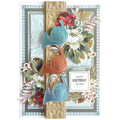 Celebrate with the Music 3D Scene Dies birthday card, featuring floral patterns, three embossed French horns, gold accents, and a layered background with elegant musical instrument details and “Happy Birthday To You” message.