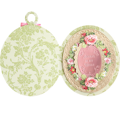 The Locket Card Dies create oval cards featuring a floral pattern and "Always in My Heart" message surrounded by pink roses—ideal for crafting keepsake-style cards with ornate frames.