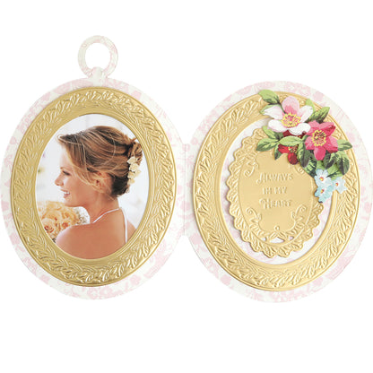 Create keepsake-style cards with the Locket Card Dies—an oval locket-shaped die set featuring space for a photo on the left and gold-embossed "Always in my heart" text with floral accents on the right, ideal for ornate frames.