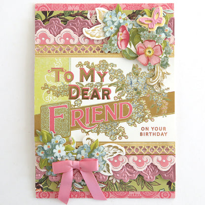 A decorative birthday card with floral designs, lace patterns, a pink bow, and "To My Dear Friend On Your Birthday" on the front, adorned with Antique Birthday Postcard Embellishment Stickers for an elegant touch.