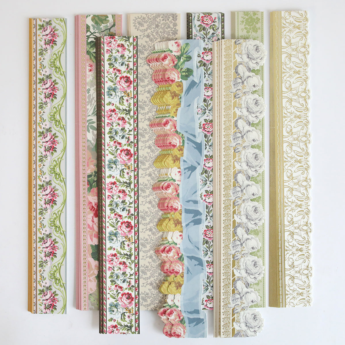 The Virginia 12" Border Stickers set includes eight floral-patterned strips in various colors and designs, ideal for decorating scrapbook pages or as border accents, all displayed vertically on a white background.