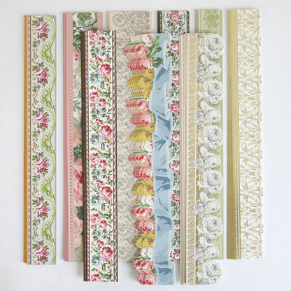 The Virginia 12" Border Stickers set includes eight floral-patterned strips in various colors and designs, ideal for decorating scrapbook pages or as border accents, all displayed vertically on a white background.