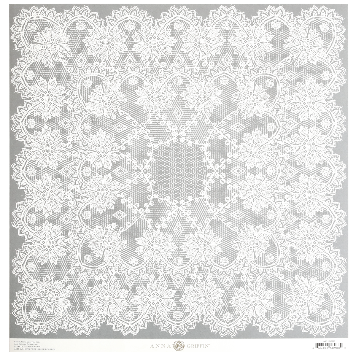 Introducing the Endora Grey Lace 12x12 Cardstock: a square lace doily with an intricate floral pattern set against a plain background. The design features detailed, delicate lacework and a central circular motif. Ideally suited for pairing with single-sided 12″ x 12″ patterned cardstock to create stunning craft projects.